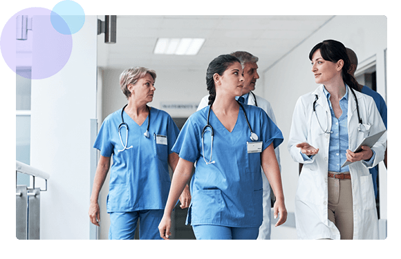 Healthcare workers walking down a hospital hallway - HealthStream